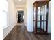 Bright hallway with beautiful hardwood floors, a display cabinet, and a glimpse into the living area at 112 Edisto Crossing Ct, Ridgeville, SC 29472