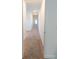 Hallway with carpet floor and white trim offering a view of a bright room at 112 Edisto Crossing Ct, Ridgeville, SC 29472