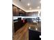 Kitchen featuring dark wood cabinets, a black appliance package, and a sink with a black faucet at 112 Edisto Crossing Ct, Ridgeville, SC 29472