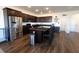 Updated kitchen with stainless steel refrigerator, dark wood cabinets, and center island with barstool seating at 112 Edisto Crossing Ct, Ridgeville, SC 29472