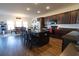 Kitchen area with a center island with barstools, modern appliances, and wood flooring at 112 Edisto Crossing Ct, Ridgeville, SC 29472