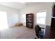 Bright office space with neutral carpet, bookshelf, and natural light from two windows at 112 Edisto Crossing Ct, Ridgeville, SC 29472