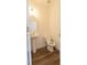Cozy powder room featuring wood-look floors, a pedestal sink, a toilet, and neutral walls at 112 Edisto Crossing Ct, Ridgeville, SC 29472