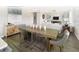 An open dining and living area featuring hardwood floors, modern decor, and plenty of natural light at 115 Royal Cainhoy Way, Huger, SC 29450