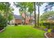 Spacious backyard featuring a lush lawn, mature trees, and a charming screened-in porch at 1278 Deep Water Dr, Mount Pleasant, SC 29464