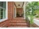 Inviting front porch with brick steps, black railing, and a cozy bench at 1278 Deep Water Dr, Mount Pleasant, SC 29464