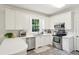 Bright kitchen features white cabinets, stainless steel appliances and tile flooring at 1278 Deep Water Dr, Mount Pleasant, SC 29464
