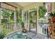 Relaxing screened porch with a view of the backyard, an outdoor rug, and patio access at 1278 Deep Water Dr, Mount Pleasant, SC 29464