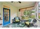 Cozy screened porch with wicker furniture, a blue door, and a tropical-themed rug at 1278 Deep Water Dr, Mount Pleasant, SC 29464