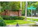 Community sign with manicured landscaping, an intersection, and American flags at 1278 Deep Water Dr, Mount Pleasant, SC 29464