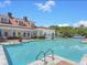 Large community pool with plenty of seating, umbrellas and lounge chairs at 1411 Telfair Way, Charleston, SC 29412