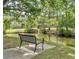 Scenic view of a park bench overlooking a tranquil pond with lush greenery and nearby residences at 1411 Telfair Way, Charleston, SC 29412