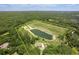 Expansive aerial view of a property with a large pond and surrounding lush greenery at 1420 Polly Point Rd, Wadmalaw Island, SC 29487