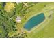 An aerial view of home showcasing surrounding landscape, pond and lush forest at 1420 Polly Point Rd, Wadmalaw Island, SC 29487