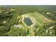 Aerial view of large acreage property featuring a serene pond bordered by lush greenery and mature trees at 1420 Polly Point Rd, Wadmalaw Island, SC 29487