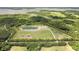 Aerial view showing acreage, pond, and home site surrounded by mature trees at 1420 Polly Point Rd, Wadmalaw Island, SC 29487
