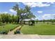 Lush backyard featuring manicured lawns, a picturesque pergola, and a serene lake view at 1420 Polly Point Rd, Wadmalaw Island, SC 29487