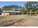 Spacious backyard featuring lush greenery, a pergola, and a charming patio area at 1420 Polly Point Rd, Wadmalaw Island, SC 29487