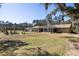 Wide view of home, lawn, and a lovely pergola with outdoor furniture at 1420 Polly Point Rd, Wadmalaw Island, SC 29487