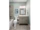 Charming bathroom with blue accent wall, tile shower, and elegant vanity, offering both style and functionality at 1420 Polly Point Rd, Wadmalaw Island, SC 29487