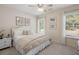 Sunlit bedroom with white furniture, soft carpet, and natural light, creating a cozy and inviting atmosphere at 1420 Polly Point Rd, Wadmalaw Island, SC 29487