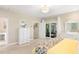 Bright bedroom with backyard patio access, neutral color palette, and white furniture creating a serene retreat at 1420 Polly Point Rd, Wadmalaw Island, SC 29487