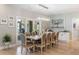 Elegant dining room filled with natural light, stylish table and access to the outdoor patio at 1420 Polly Point Rd, Wadmalaw Island, SC 29487
