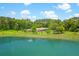 Stunning exterior view of home, featuring a serene pond and lush greenery at 1420 Polly Point Rd, Wadmalaw Island, SC 29487