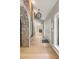 Inviting entryway featuring light hardwood floors and a decorative brick archway at 1420 Polly Point Rd, Wadmalaw Island, SC 29487
