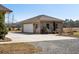 Detached brick garage with a concrete driveway and well-maintained landscaping at 1420 Polly Point Rd, Wadmalaw Island, SC 29487