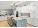 Bright eat-in kitchen showcasing a center island with seating, stainless appliances and stylish decor at 1420 Polly Point Rd, Wadmalaw Island, SC 29487