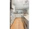 Beautiful kitchen features a large island, white cabinets, stainless appliances and hardwood floors at 1420 Polly Point Rd, Wadmalaw Island, SC 29487