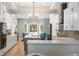 Bright kitchen with white cabinets, a center island, stainless appliances, and a view to a sunroom at 1420 Polly Point Rd, Wadmalaw Island, SC 29487