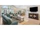 Bright open living space flows to dining with light wood floors and neutral walls at 1420 Polly Point Rd, Wadmalaw Island, SC 29487