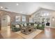 Open living area with a comfortable sectional, brick accent wall, and lots of natural light at 1420 Polly Point Rd, Wadmalaw Island, SC 29487