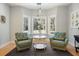 Cozy sitting room featuring two armchairs and bright windows offering views of the outside at 1420 Polly Point Rd, Wadmalaw Island, SC 29487