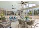 Bright and airy sunroom with wicker furniture and a glass-top dining table at 1420 Polly Point Rd, Wadmalaw Island, SC 29487