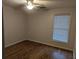 An empty bedroom with sleek hard wood floor and a window at 1530 Fort Johnson Rd # 3F, Charleston, SC 29412