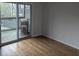Bedroom boasts wood floors and sliding glass doors to a private deck with seating, perfect for relaxing outdoors at 1530 Fort Johnson Rd # 3F, Charleston, SC 29412