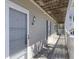 Well-lit exterior hallway with wooden floors and covered ceilings at 1530 Fort Johnson Rd # 3F, Charleston, SC 29412