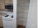 Clean kitchen with stainless steel microwave and pantry space at 1530 Fort Johnson Rd # 3F, Charleston, SC 29412
