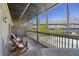 Screened porch with outdoor seating, overlooking the pool and condo building at 1530 Fort Johnson Rd # 3F, Charleston, SC 29412