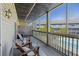 Relaxing screened-in porch features wooden furniture and a view of the community pool at 1530 Fort Johnson Rd # 3F, Charleston, SC 29412