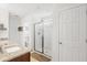 Bright bathroom with double sink granite countertop vanity, glass shower enclosure, and separate toilet room at 1532 Roustabout Way, Charleston, SC 29414