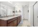 Bright bathroom with double sink granite countertop vanity and glass shower enclosure with tiled floors at 1532 Roustabout Way, Charleston, SC 29414