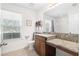 Bright bathroom featuring a granite countertop, vanity, toilet, and a window for natural light at 1532 Roustabout Way, Charleston, SC 29414