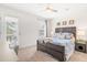 Bedroom featuring a dark wood bed frame, neutral carpet, light color walls, a ceiling fan, and lots of light at 1532 Roustabout Way, Charleston, SC 29414