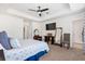 Bedroom featuring a tray ceiling, neutral carpet, a TV, an ensuite bathroom, and a walk-in closet at 1532 Roustabout Way, Charleston, SC 29414