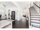 Bright and airy entryway with hardwood floors, staircase, and access to multiple rooms at 1532 Roustabout Way, Charleston, SC 29414