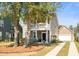 Charming two-story home with a front porch, swing, well-manicured lawn, and attached garage at 1532 Roustabout Way, Charleston, SC 29414
